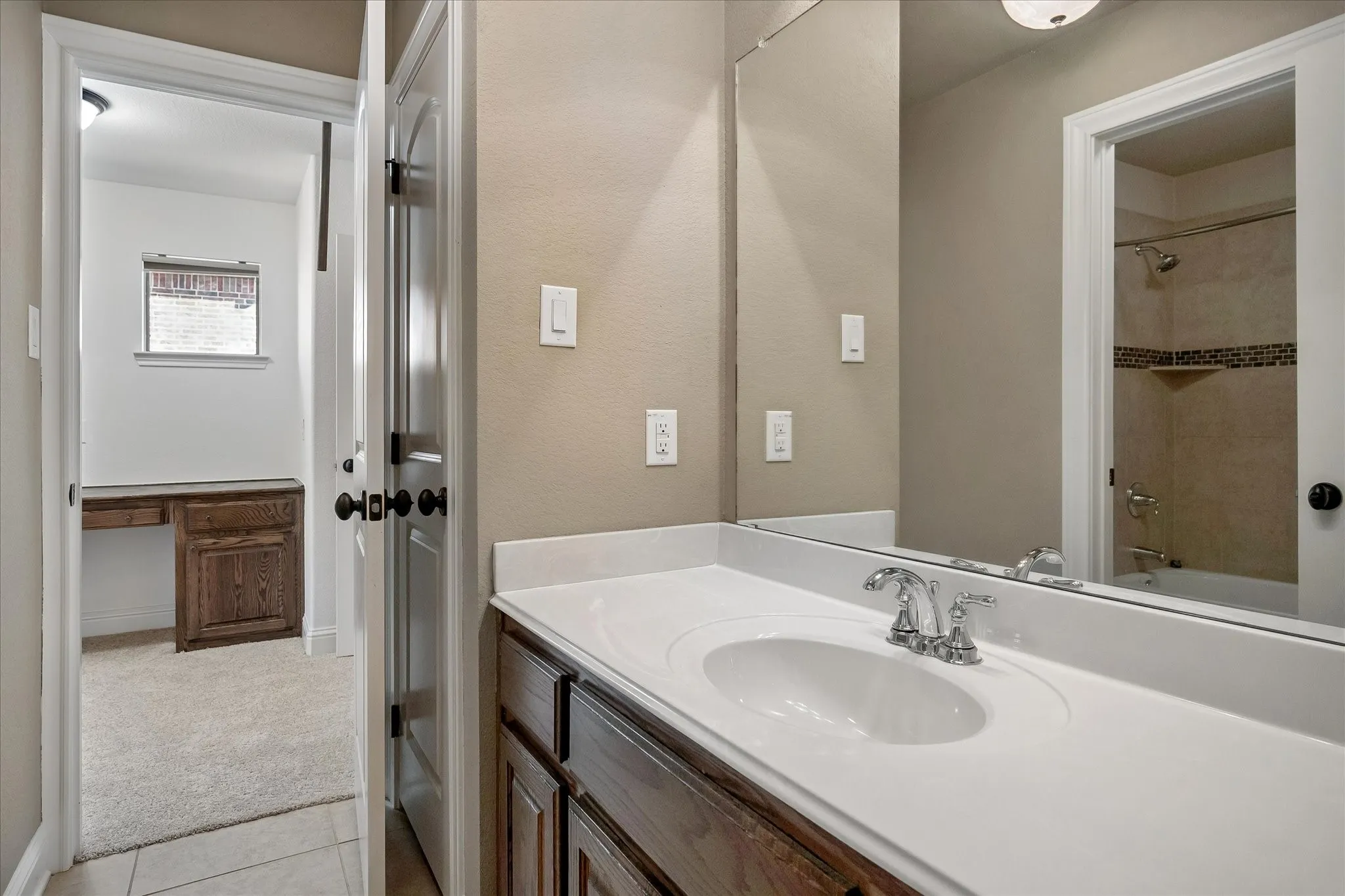 This full bath offers access to the game room and media room.