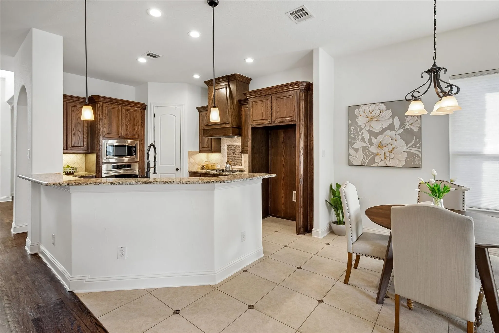 Gorgeous kitchen with wood cabinets and stainless steel appliances.