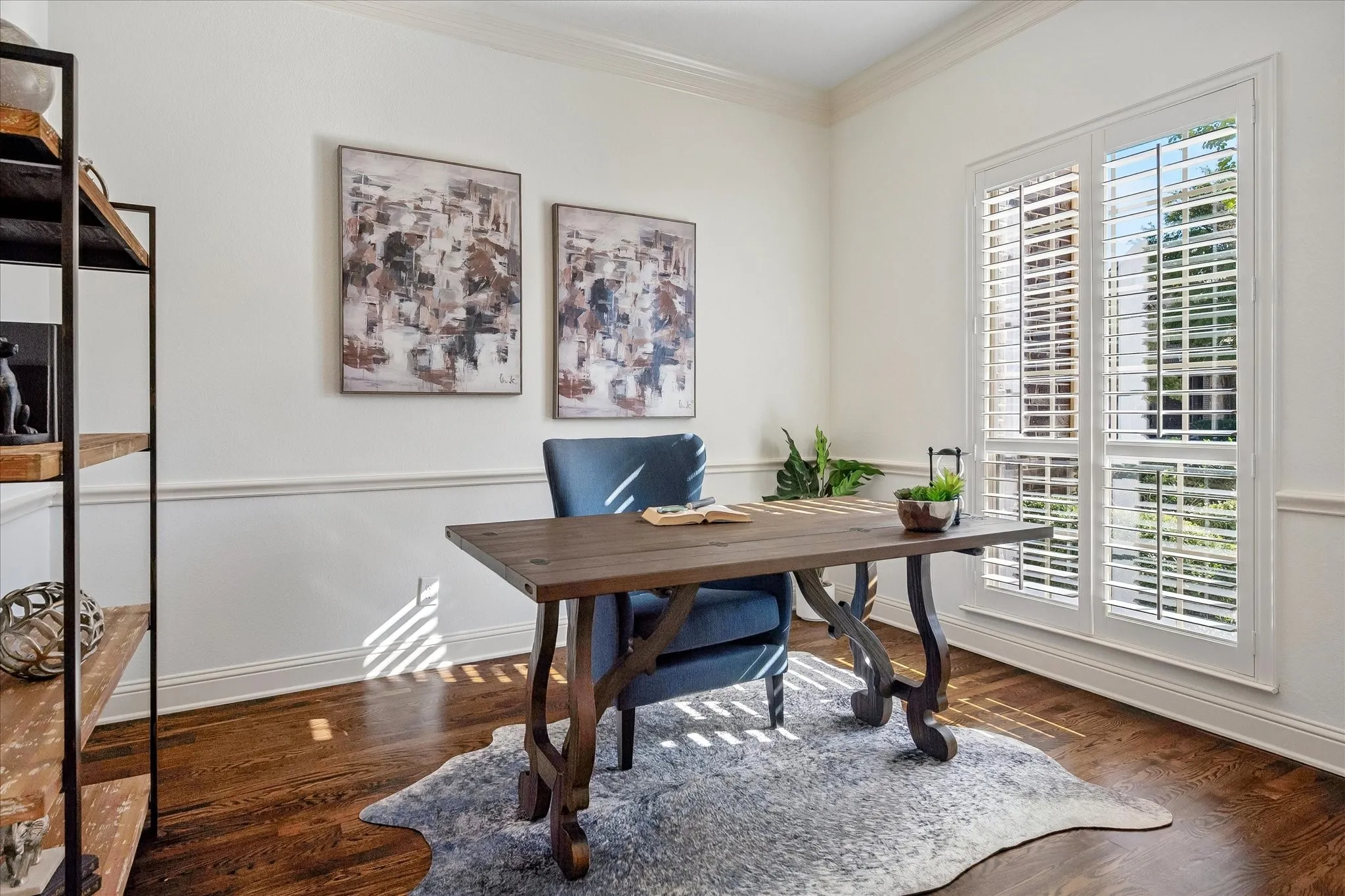 Spacious office with great natural light, chair rail and custom shutters.