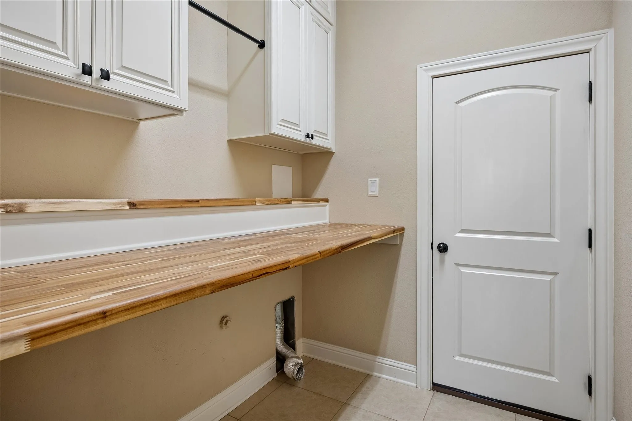 Spacious utility room with a hugh storage area under the stairs, built in cabinets