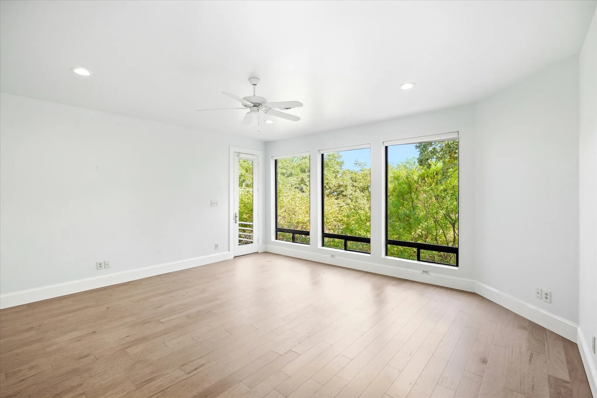 Wood-finish flooring, recessed lighting, and a ceiling fan