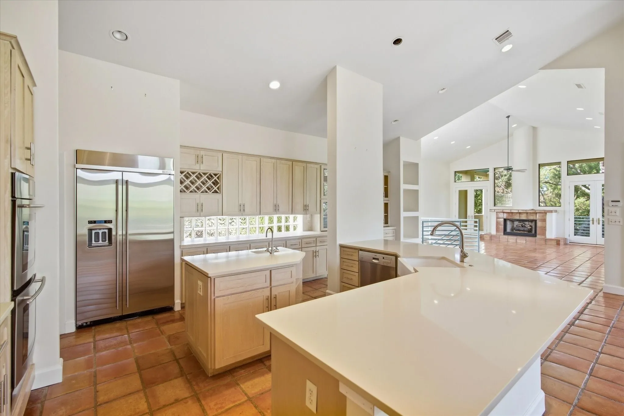 Spacious kitchen with a center island, extensive light-toned cabinetry, and stainless steel appliances