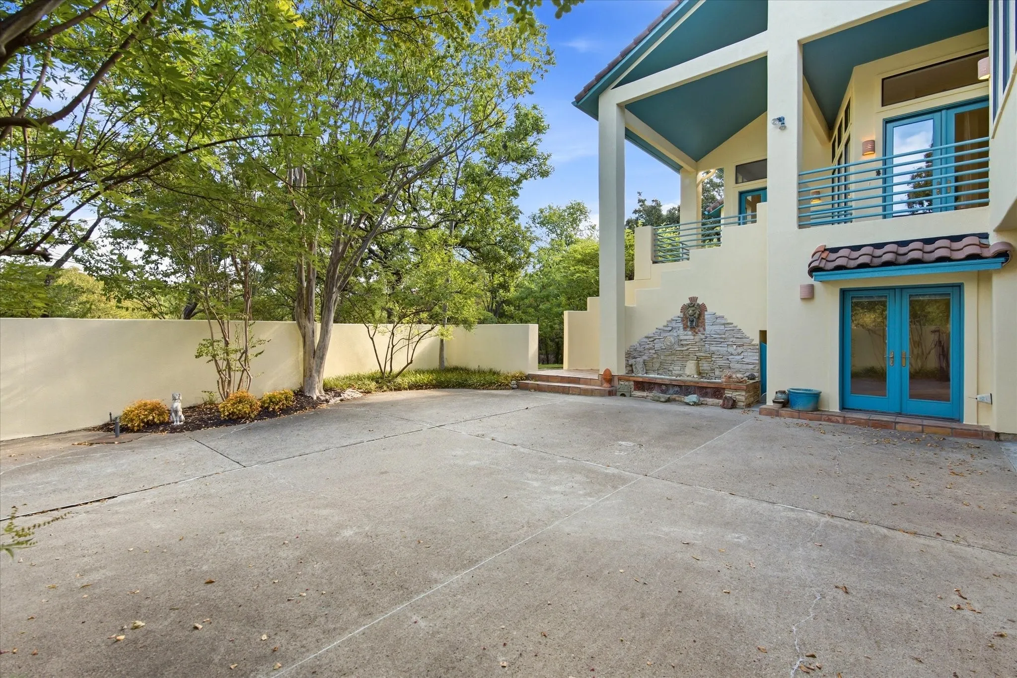 Multi-level stucco exterior with teal accents