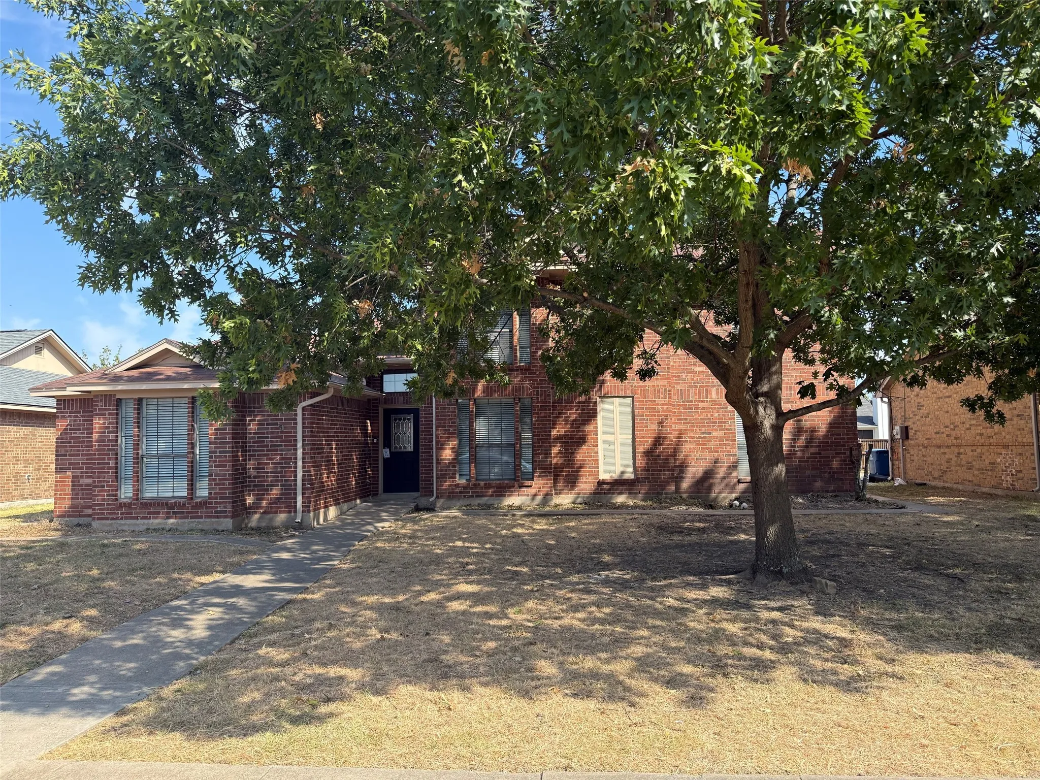 Brick exterior with gabled roofline and covered entryway