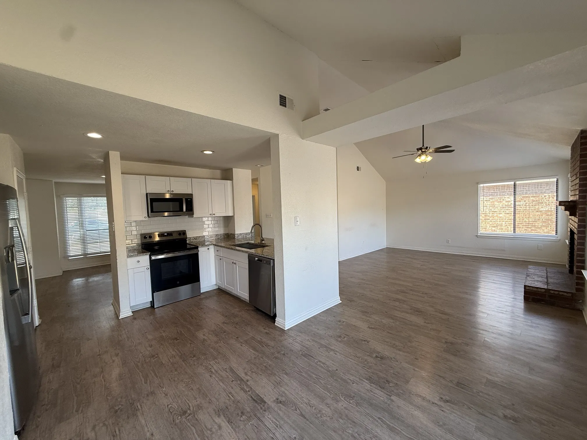 Kitchen with white cabinetry, stainless steel appliances, and a subway tile backsplash