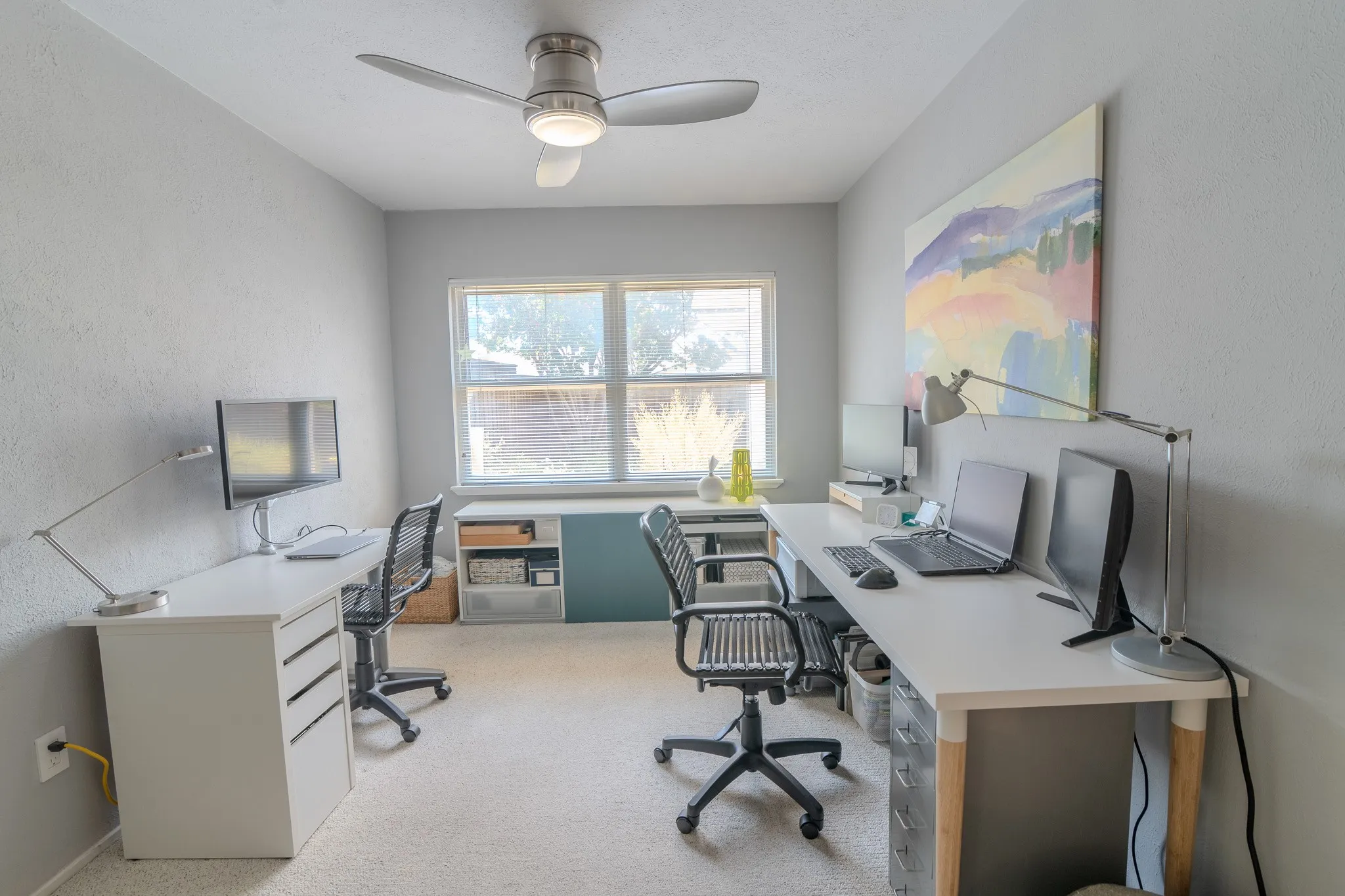Recessed window with natural light, ceiling fan with integrated lighting, built-in cabinetry, and neutral wall tones