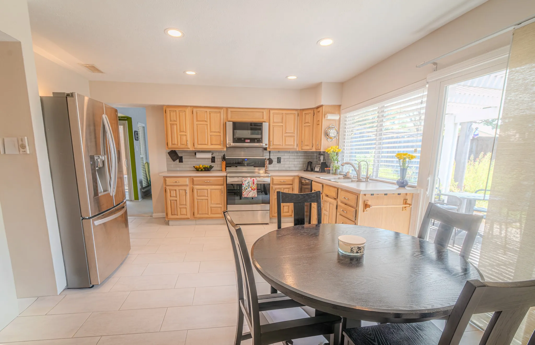 Kitchen featuring wood cabinetry, stainless steel appliances, recessed lighting, and tile flooring