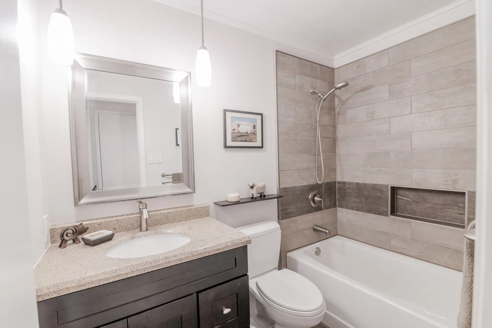 Vanity with a light-colored countertop, undermount sink, and dark wood-finish cabinetry
