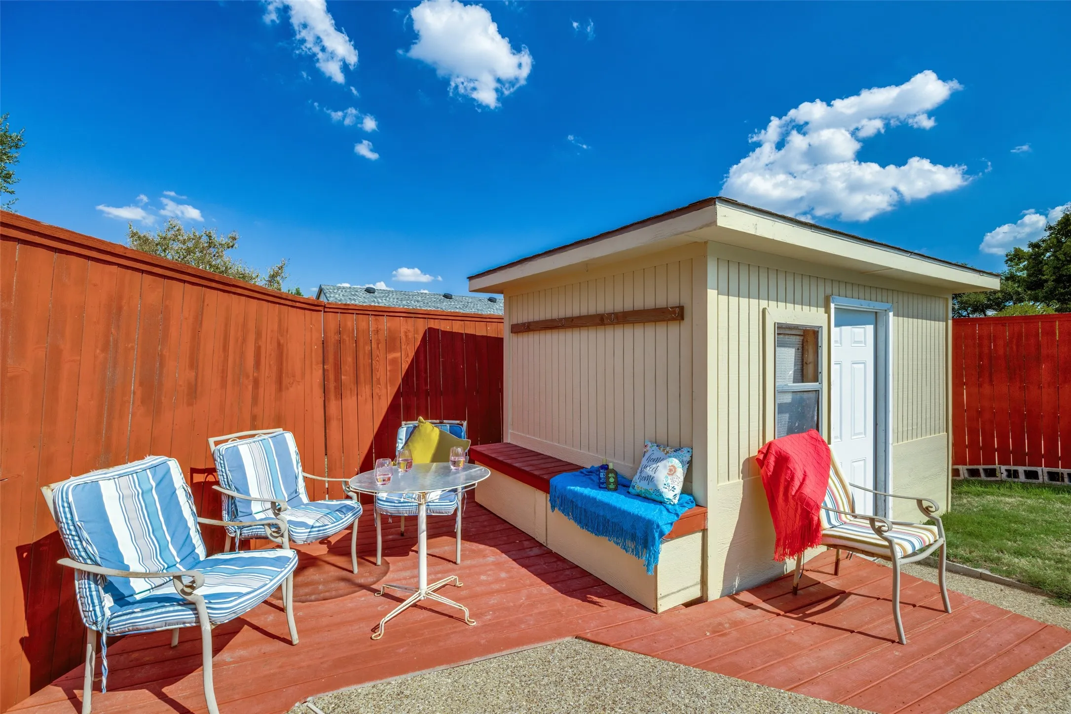 Private outdoor space with a detached shed and a built-in outdoor bench