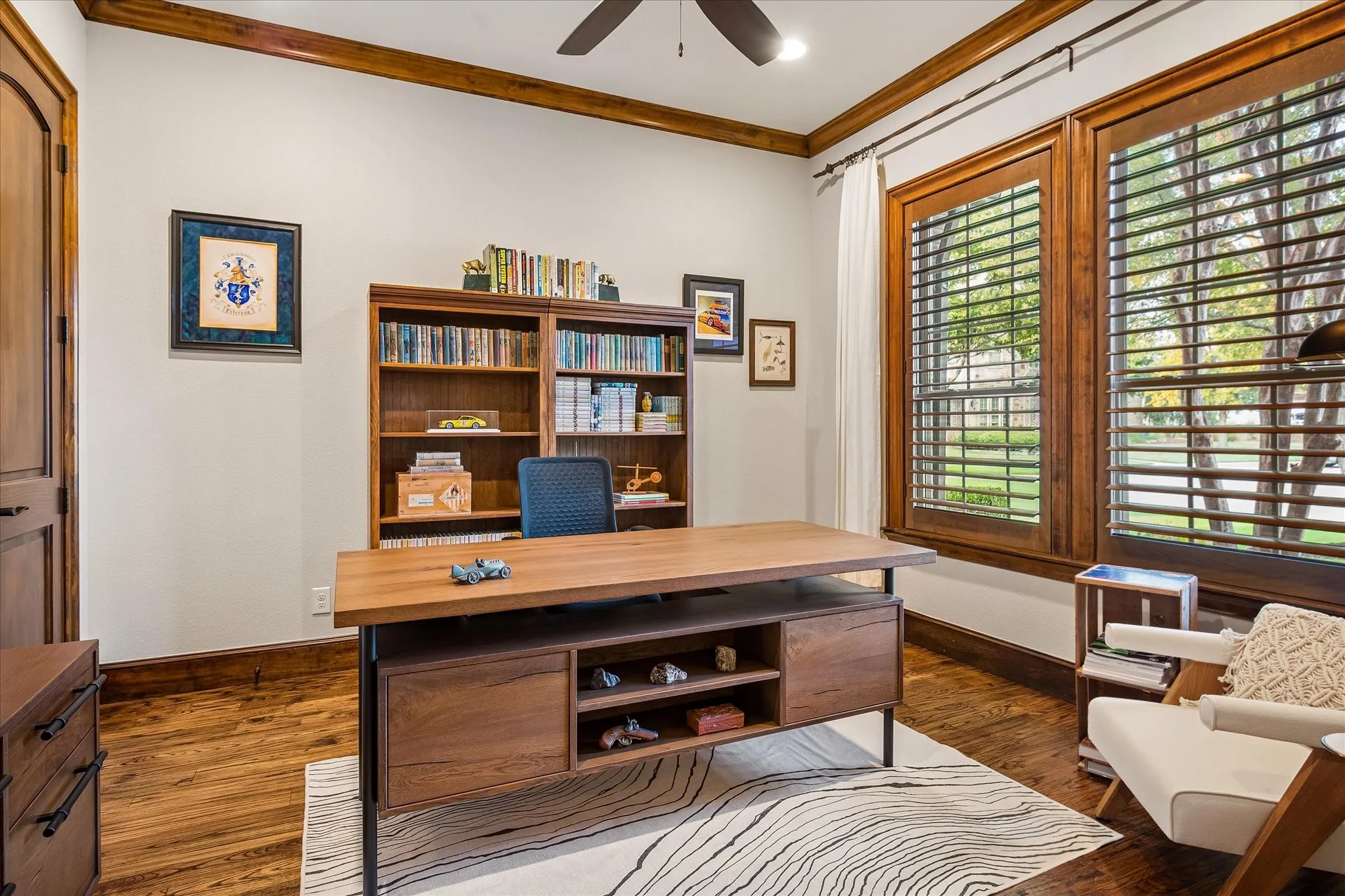 Main level office with French doors, plantation shutters and wood floors.