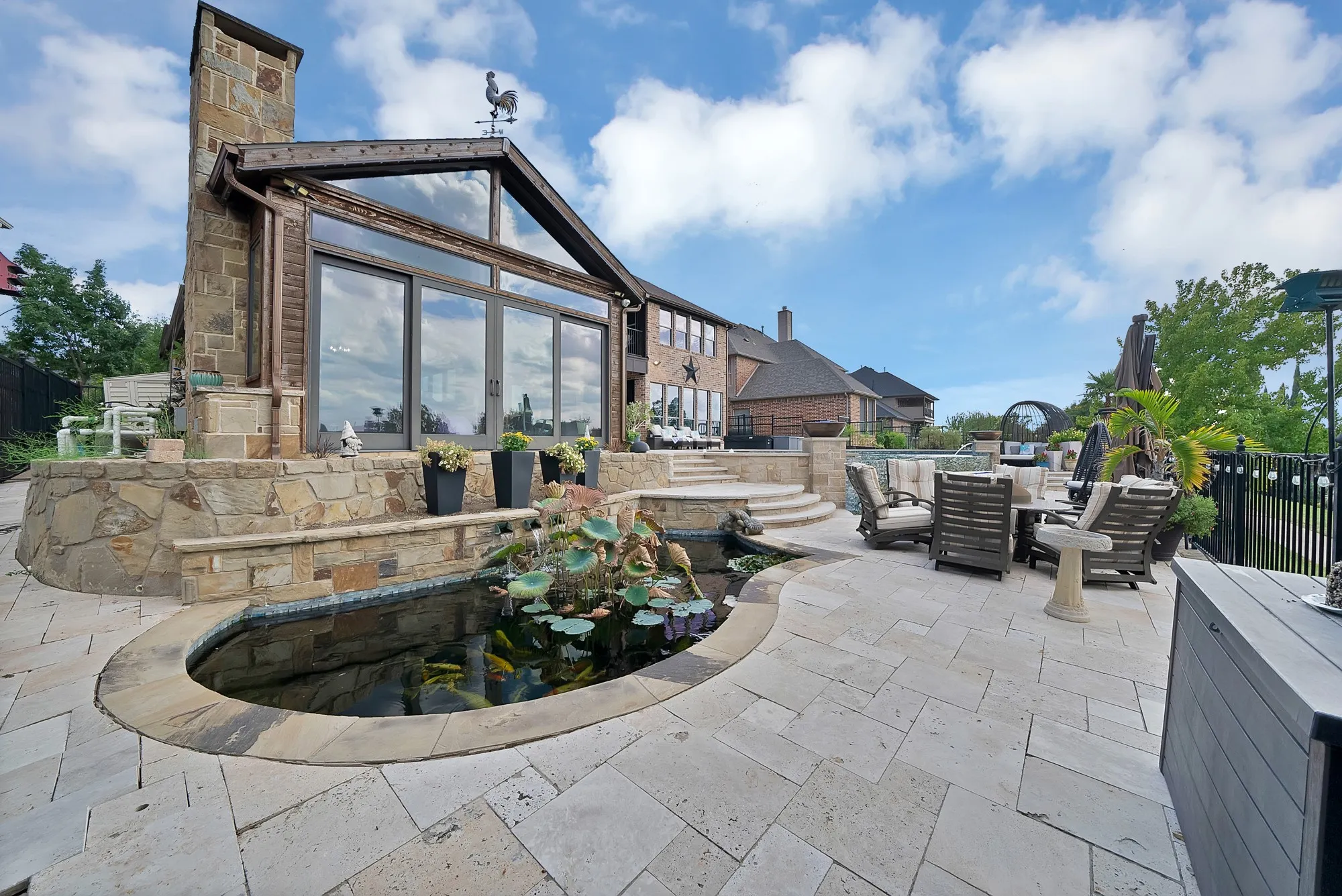 Multiple levels of thoughtfully designed outdoor living spaces create an exceptional setting for entertaining, while a tranquil koi pond adds a beautiful and serene focal point to your private oasis.
