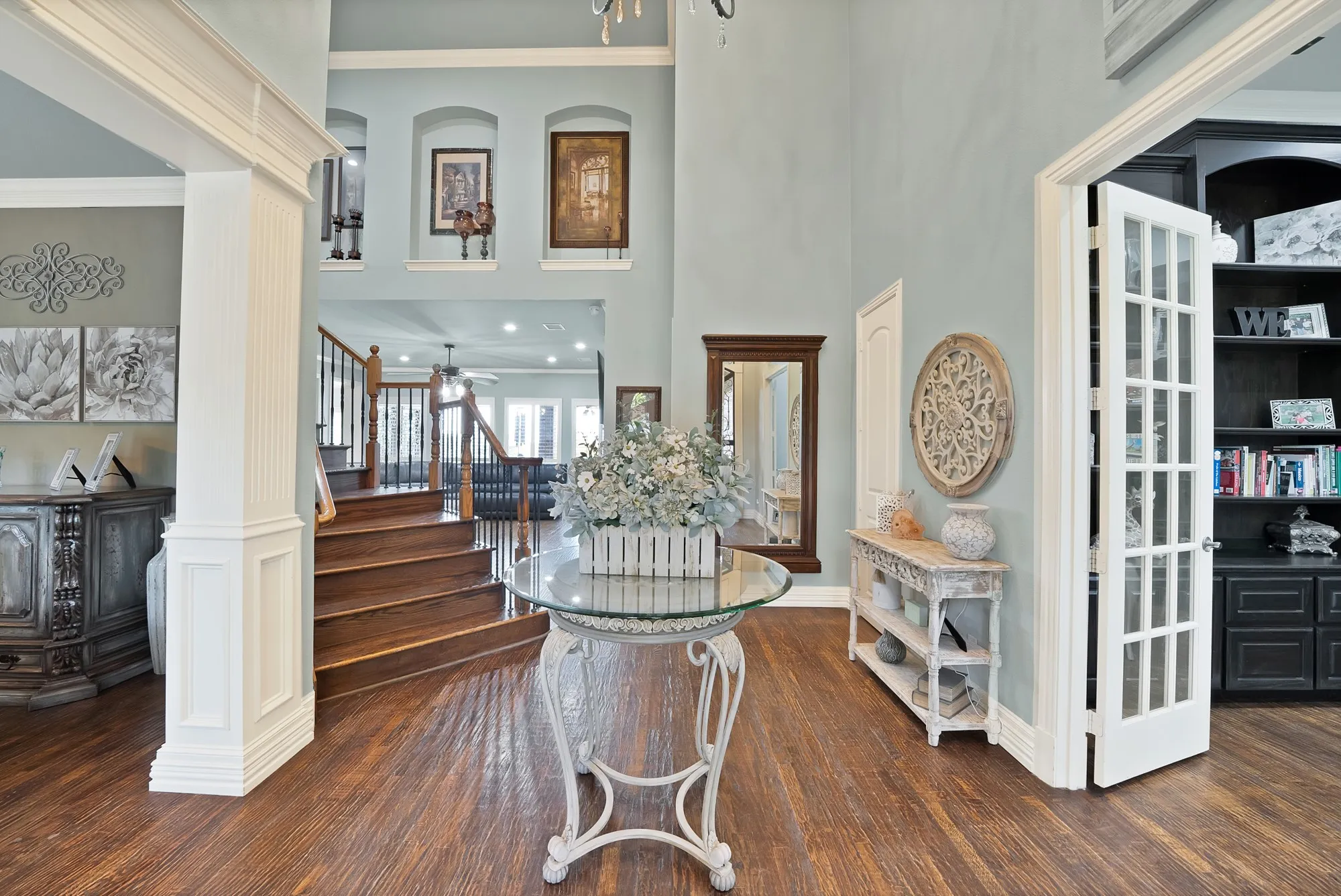 The breathtaking entry sets the tone with fresh paint, beautiful hardwood flooring, soaring ceilings, and an abundance of natural light, creating an inviting sense of elegance from the moment you enter.