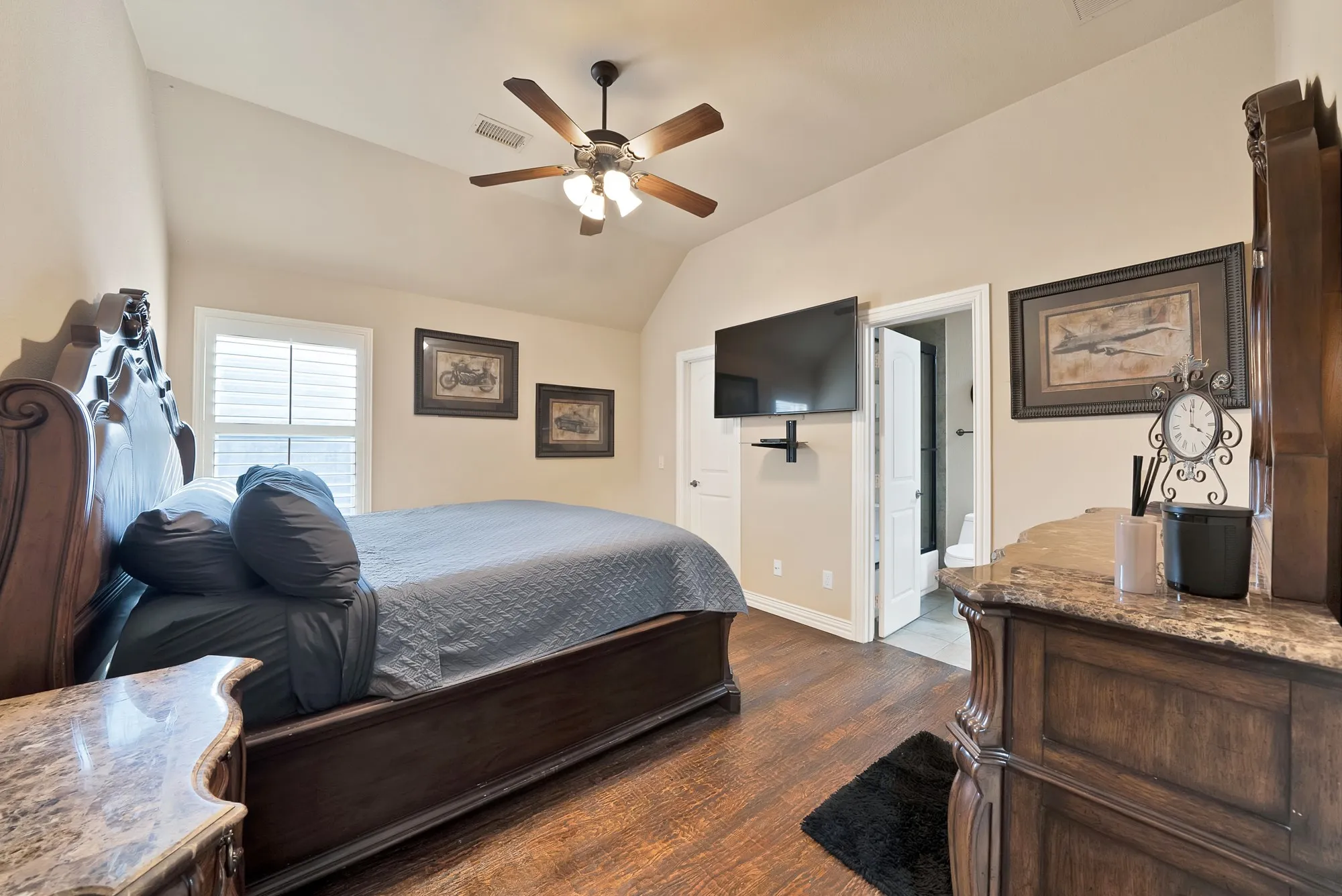 Spacious secondary bedroom upstairs offers a private retreat with an updated en-suite bathroom, providing comfort, privacy, and convenience.
