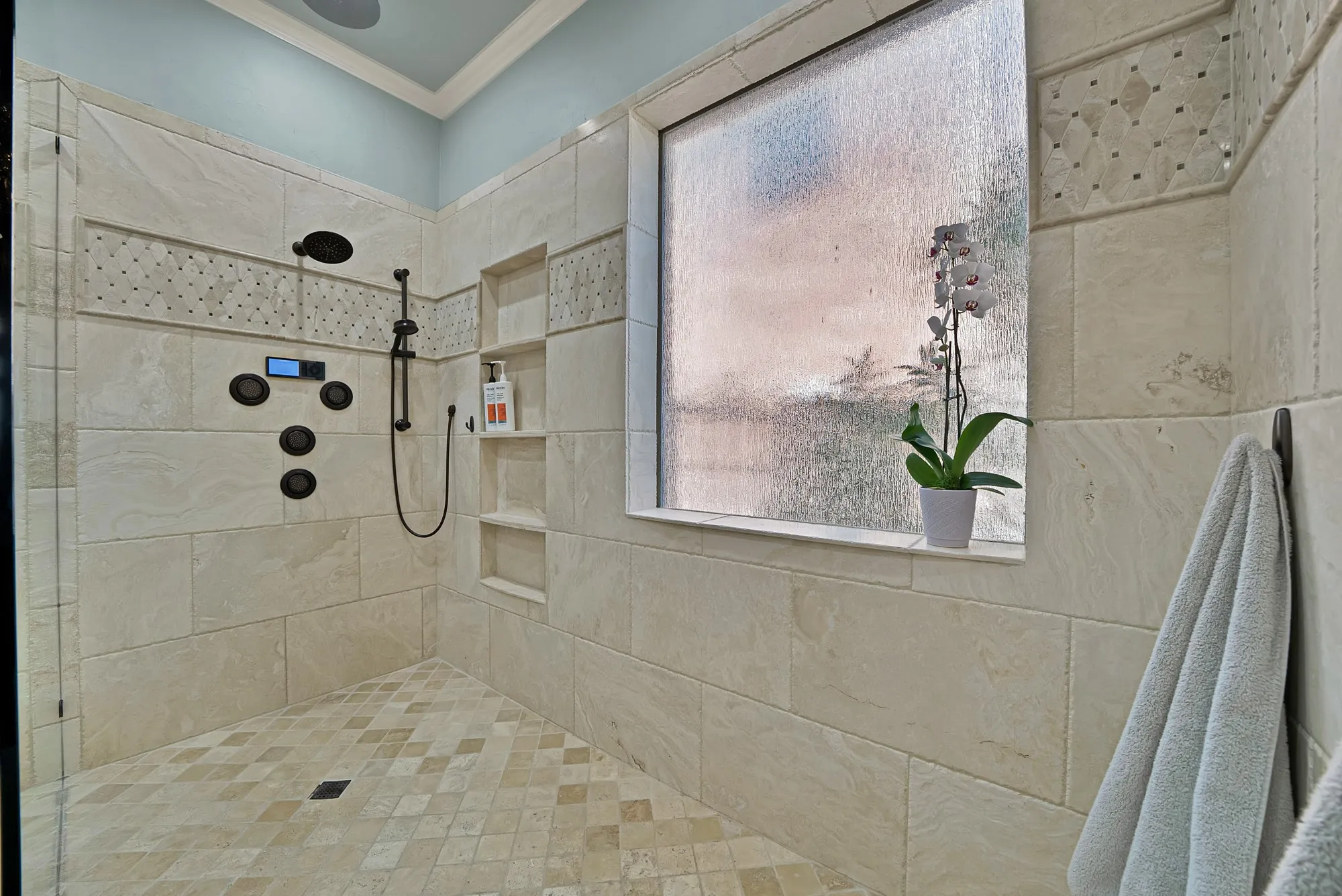 Oversized walk-in shower that feels like stepping into a private luxury retreat.