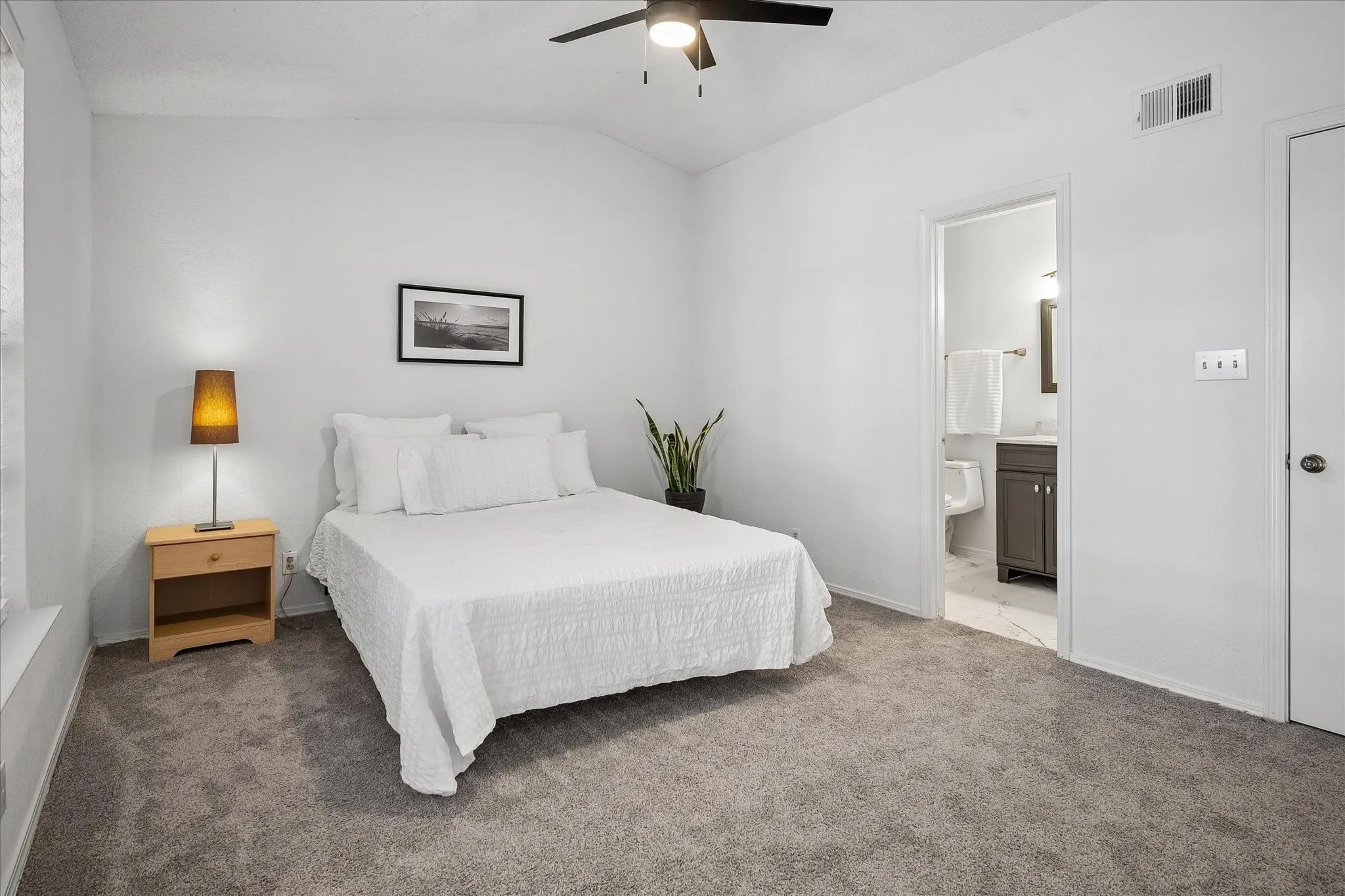Primary bedroom is light and bright and has an ensuite bathroom, ceiling fan, large walk in closet with room to store linens.