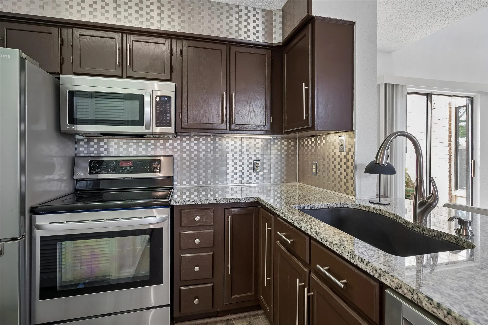 Dramatic backsplash from counter to ceiling. Lazy susan, Bosch dishwater. stainless steel appliances add to the fresh crisp look throughout this home!