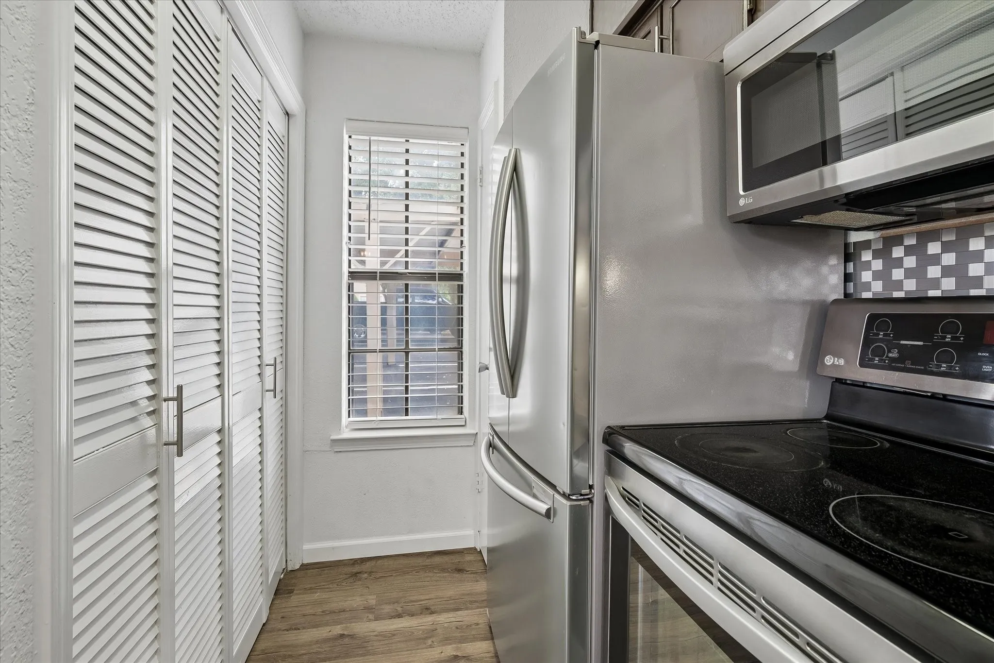 Window at the end of the kitchen, nice sized second pantry area and washer/ dryer area.