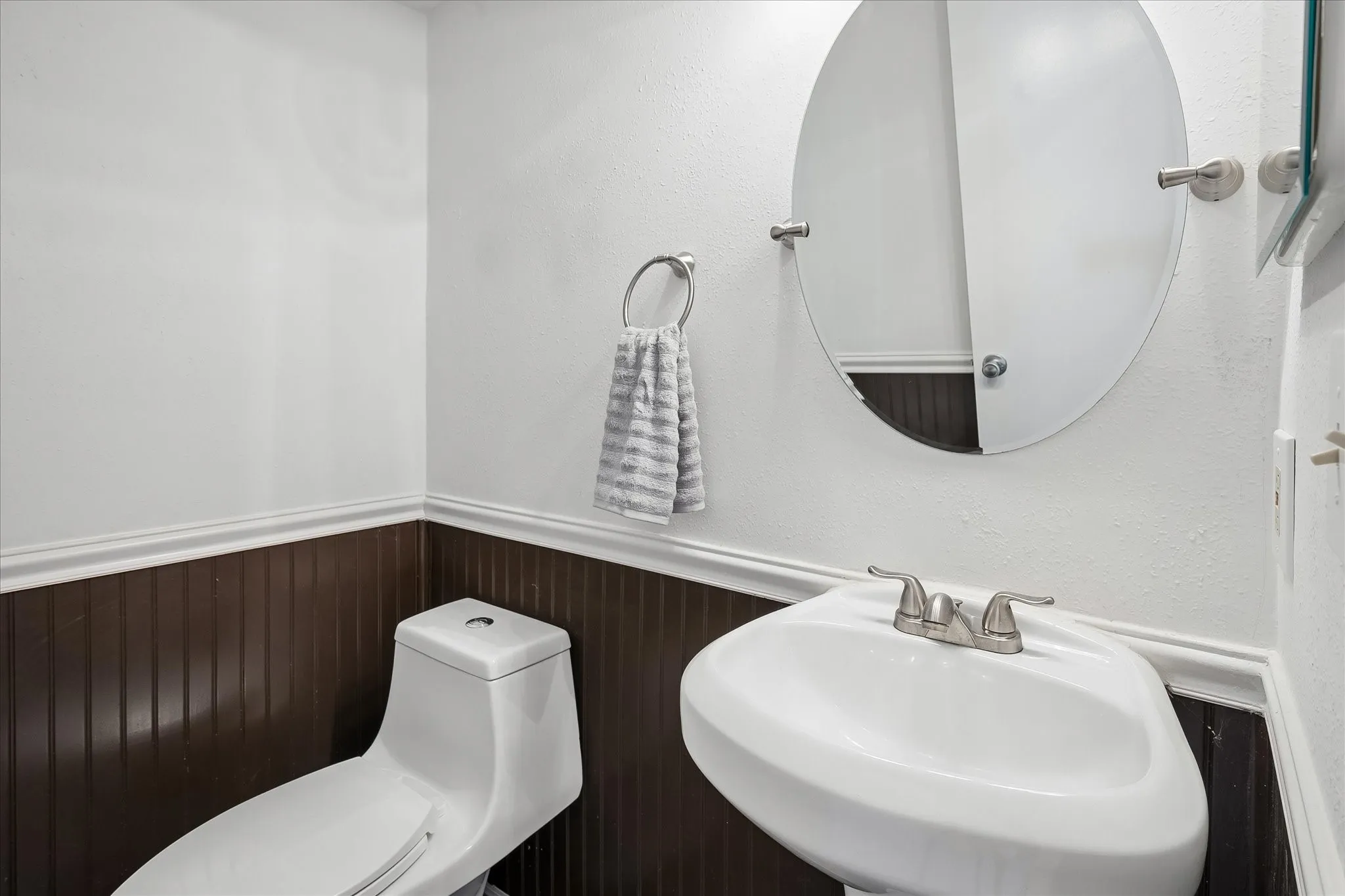 1/2 bath has paneling and a linen closet. It is located on the 1st floor.