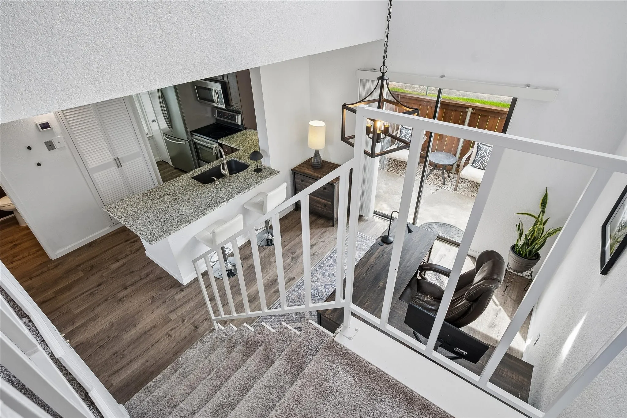 View from staircase looking into dining/ study area, kitchen and backyard patio!
