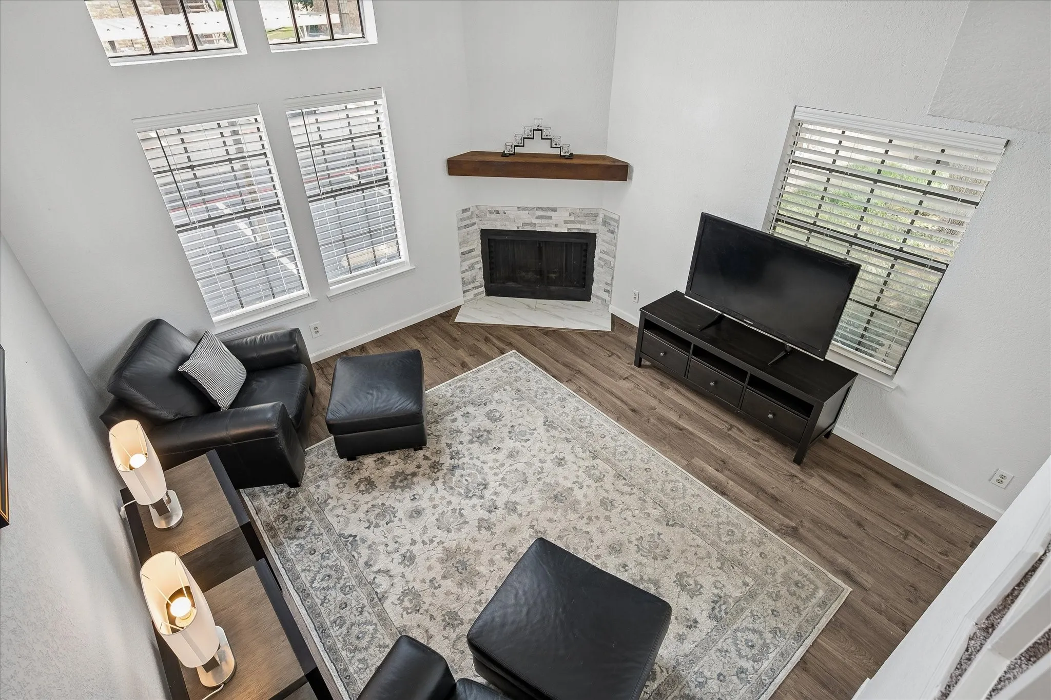 Dramatic two story vaulted ceilings, two story windows and a fireplace make this living room a stand out!