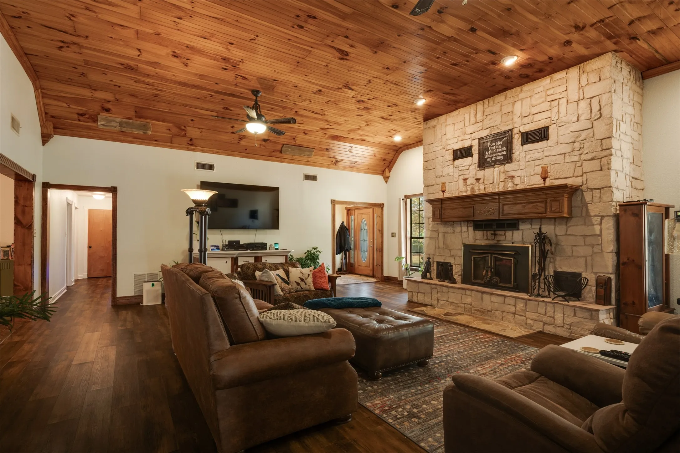 Vaulted wood-paneled ceiling with recessed lighting and ceiling fan