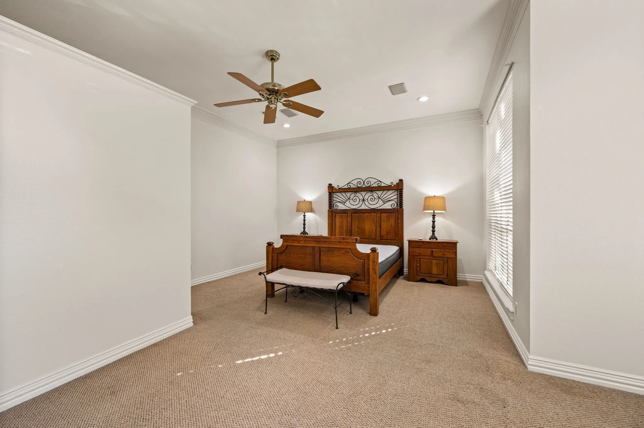 Carpeted room with crown molding, recessed lighting, and a ceiling fan