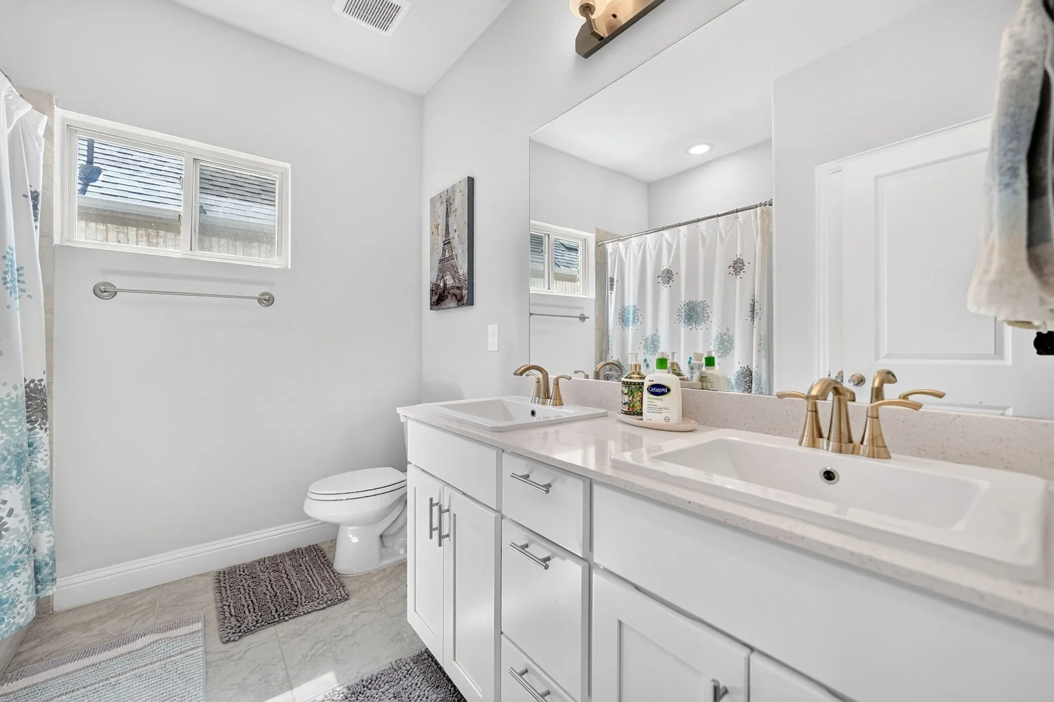 Dual vanity with integrated sinks and brass-finish fixtures