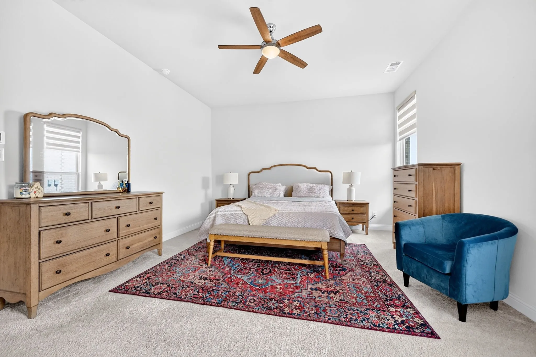White walls with carpeted flooring, featuring a ceiling fan with integrated lighting