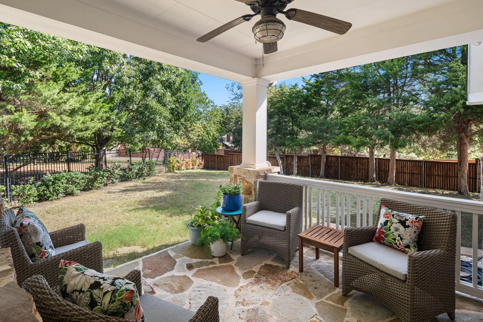 This outdoor living area and covered patio is directly adjacent to your breakfast and living areas with serene views of the oversized private yard.  This flagstone patio extends the length of the side of the home towards the front porch.