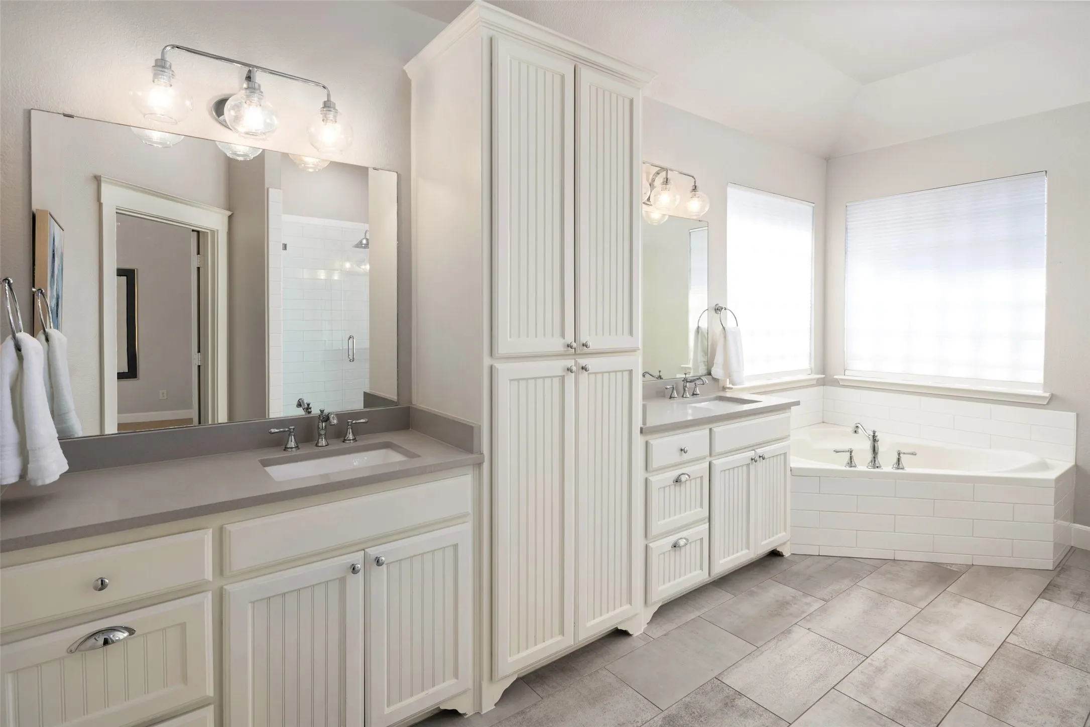 Primary Bathroom features Updated Walk In Shower, Quartz Vanities, Garden Tub and Oversized Walk In Closet!