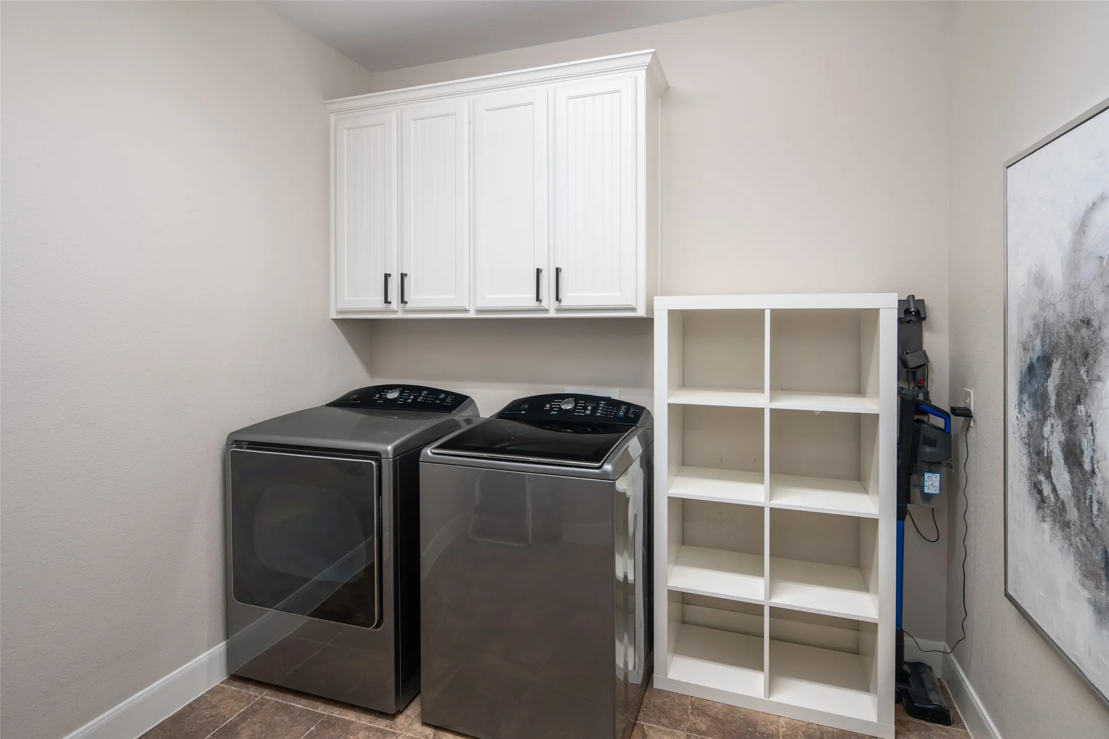 Utility Room with full size washer dryer area, room for storage or 2nd refrigerator.