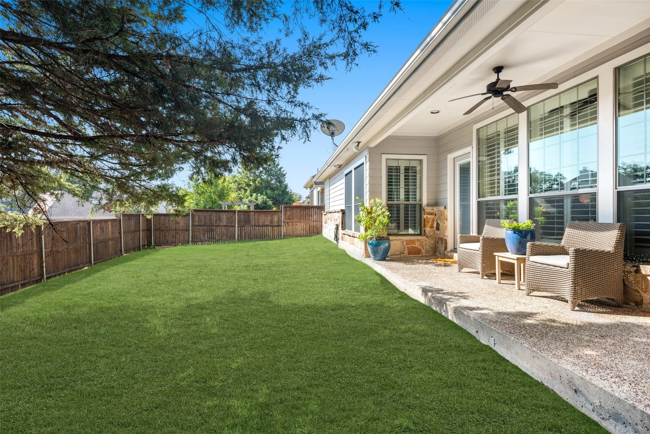 Covered Patio and Backyard Setting with plenty of room for play, pets or just time to relax!