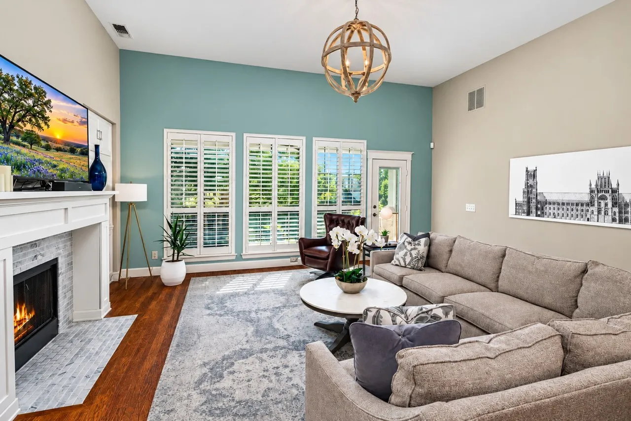 Gorgeous Living Area with Open Floorplan and seamless flow for everyday living or entertaining! Fireplace with tile accent, Built Ins, Storage, Handscraped Hardwood Floors, Plantation Shutters, Decorative Lighting and Views to the Private backyard!