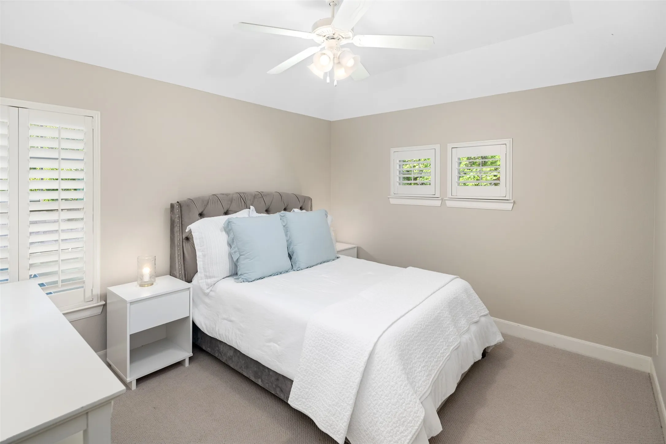 Secondary Bedroom with generous walk in closet and lovely views to the mature trees in the front yard!