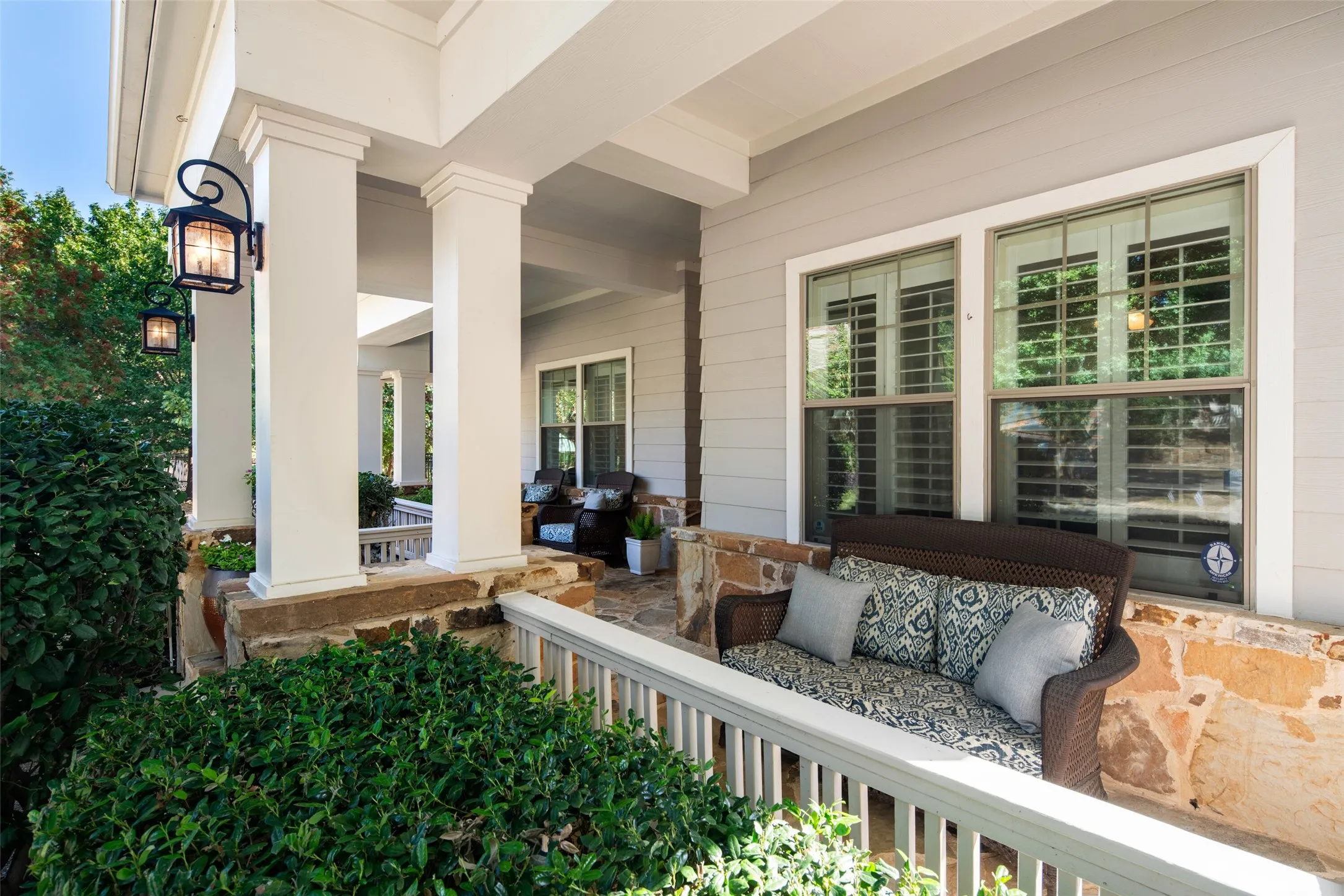 Flagstone Front Porch with generous seating areas and mature landscaping!