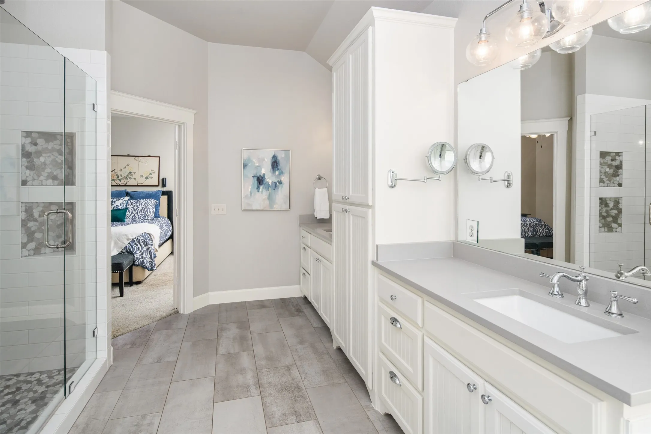 Updated Spa Style Primary Bathroom with  Quartz Vanities and Storage.