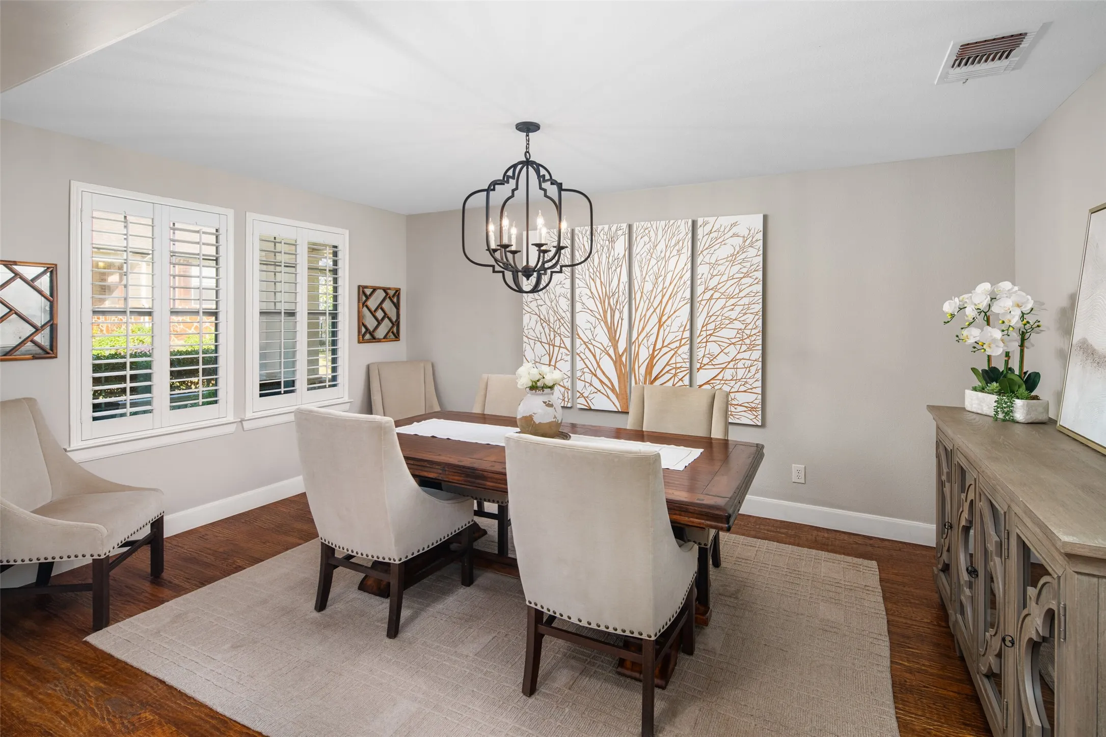 Formal Dining Area features Handscraped Hardwood Floors, Plantation Shutters, Decorative Lighting and plenty of room for entertaining.