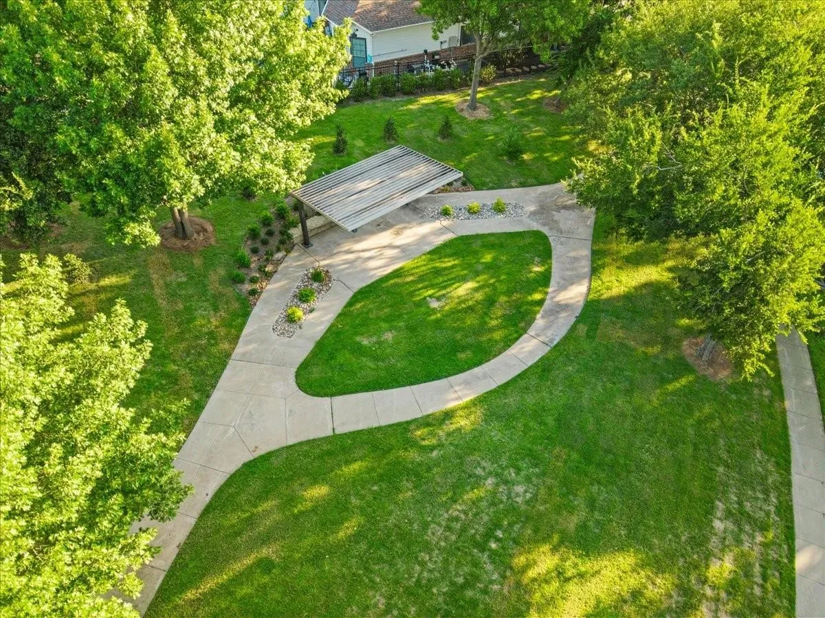 The Park at Montgomery Farms Greenbelt area with benches, landscaping and nearby access to miles of walking trail system in Allen!