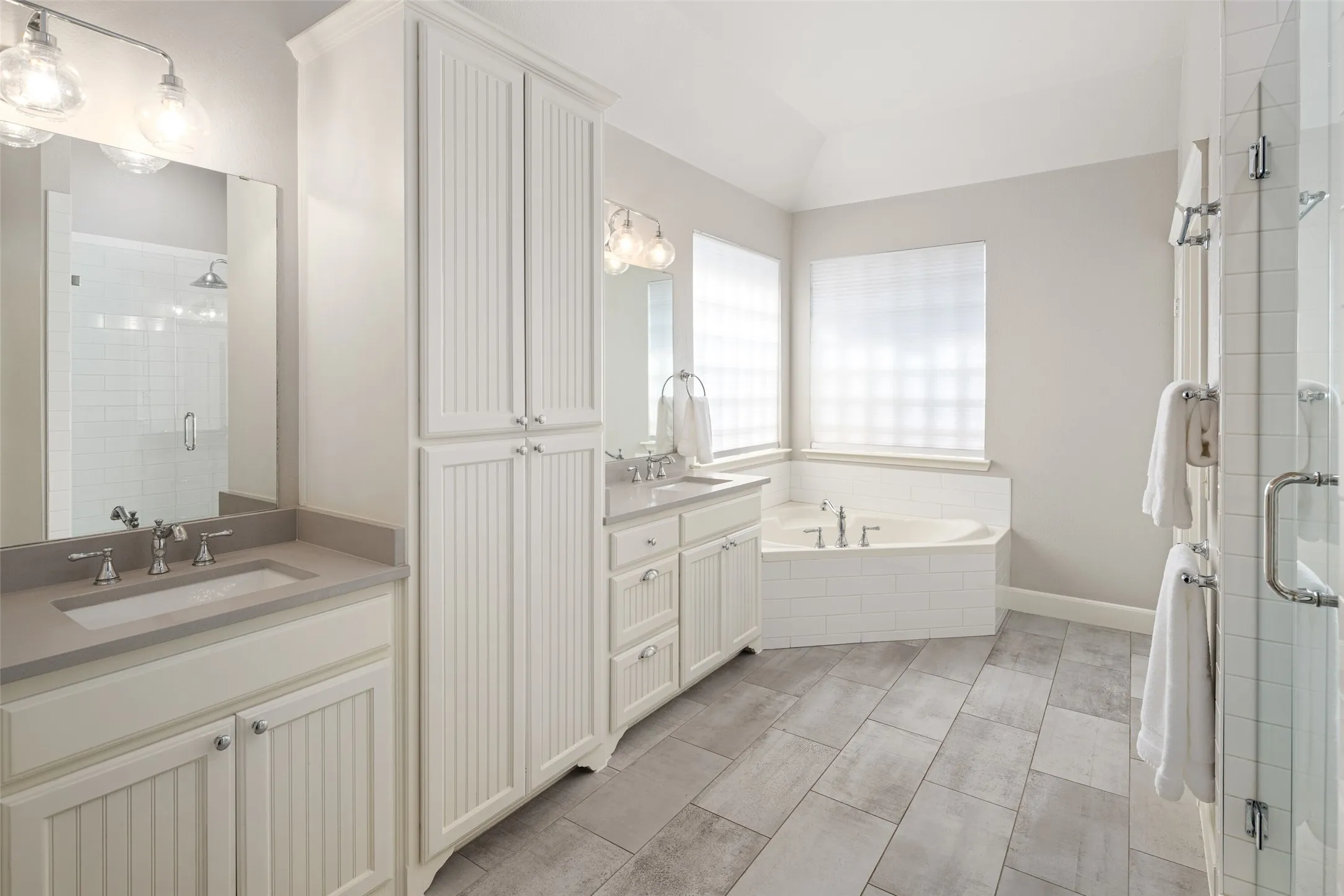UPDATED Spa Style Primary Bathroom with separate Vanities, Quartz Counters, Garden Tub, Extra Storage, Separate Shower with Frameless Glass, Updates fixtures, and wait until you see the Primary Closet!