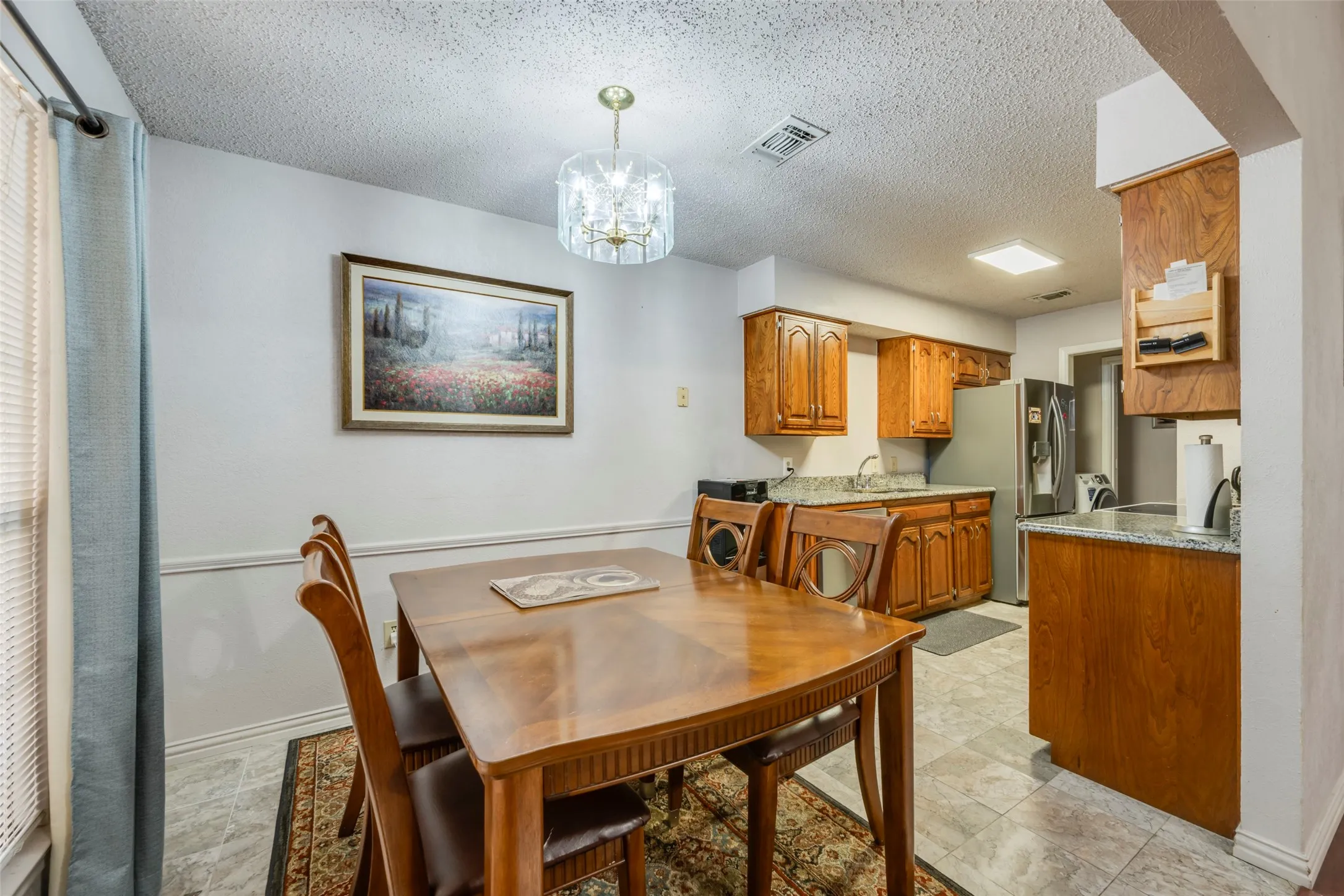Dining area featuring a decorative chandelier and wainscoting