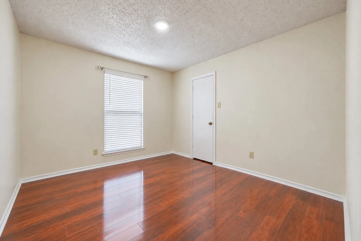Recessed lighting, wood-finish flooring, and window with blinds