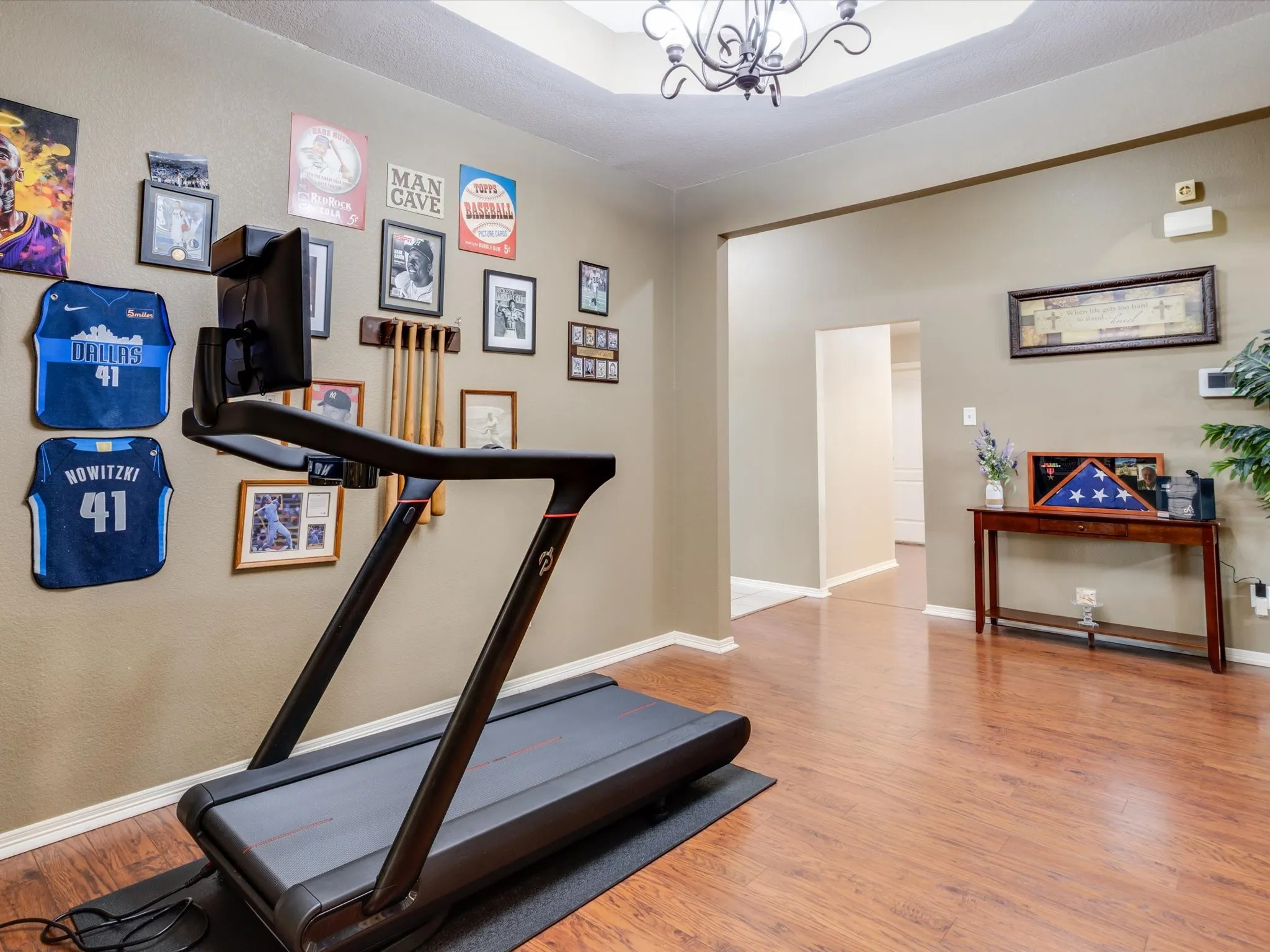 Wood-finish flooring with neutral wall tones and a tray ceiling