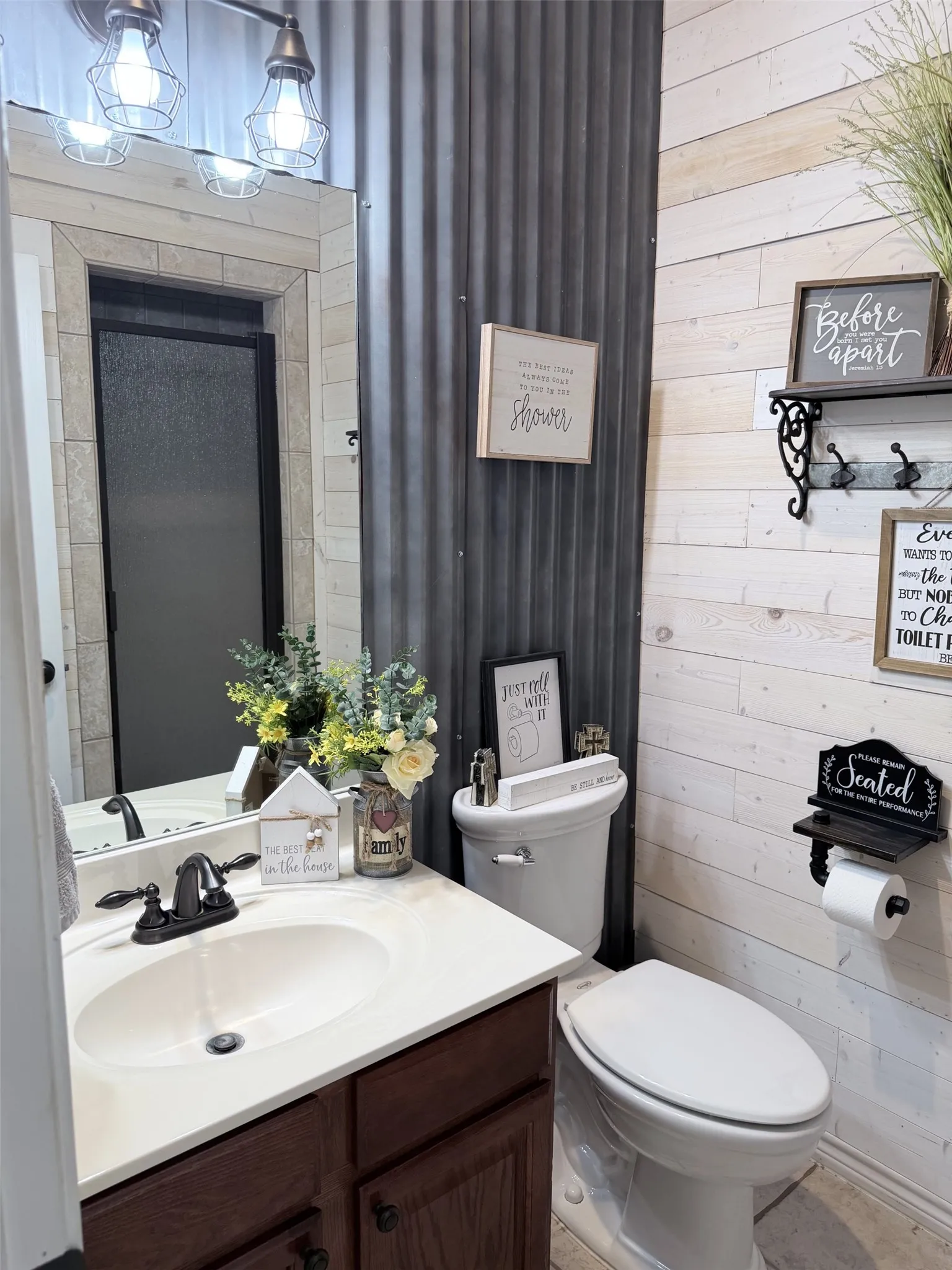 Bathroom featuring a dark wood-finish vanity with a white countertop, an oval undermount sink, and a dark bronze-finish faucet