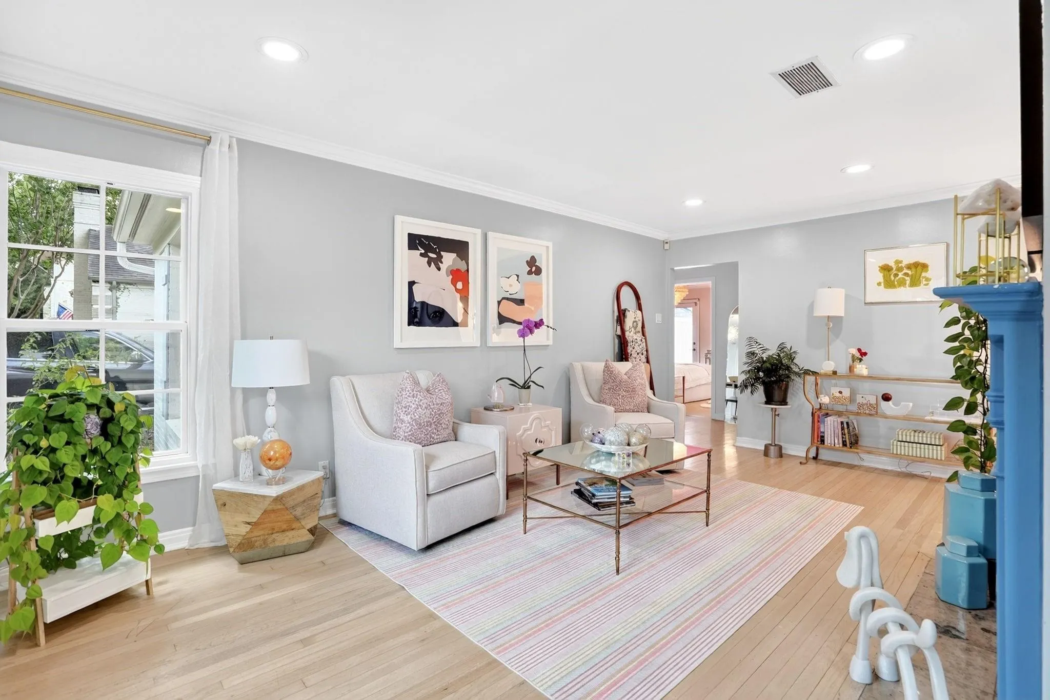 Hardwood flooring, recessed lighting, crown molding, double-hung windows, and a decorative fireplace