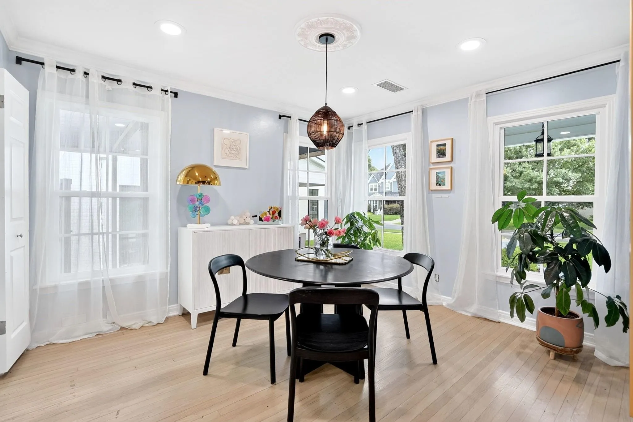 Light wood-finish flooring complements the crown molding