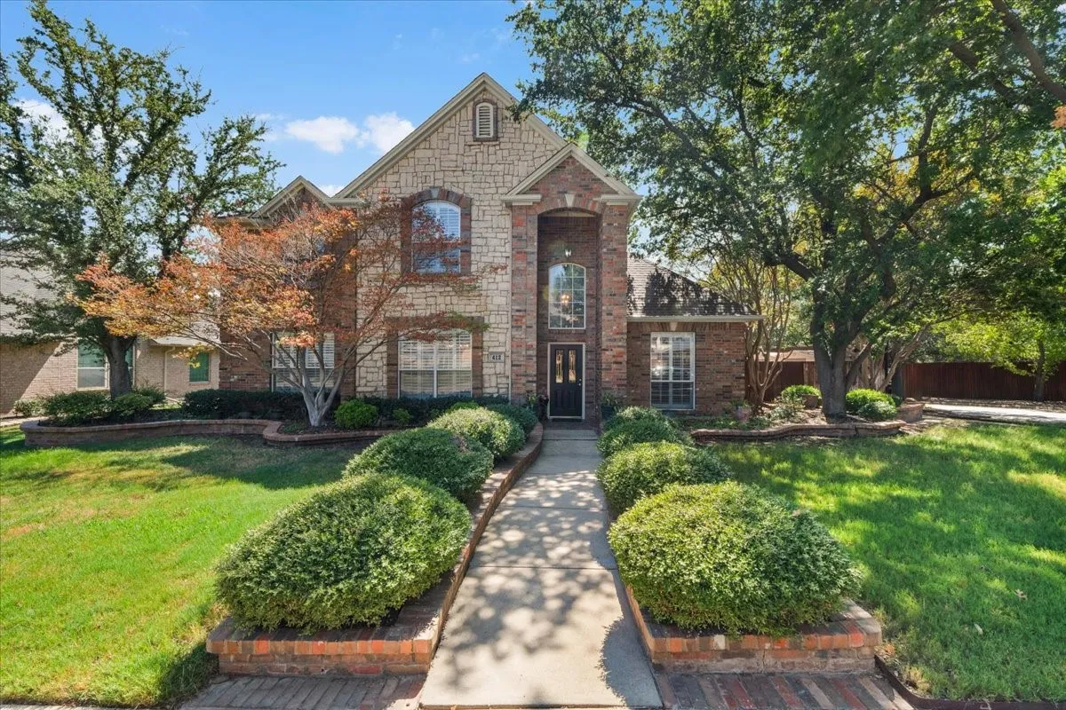 Two-story brick and stone exterior with arched windows