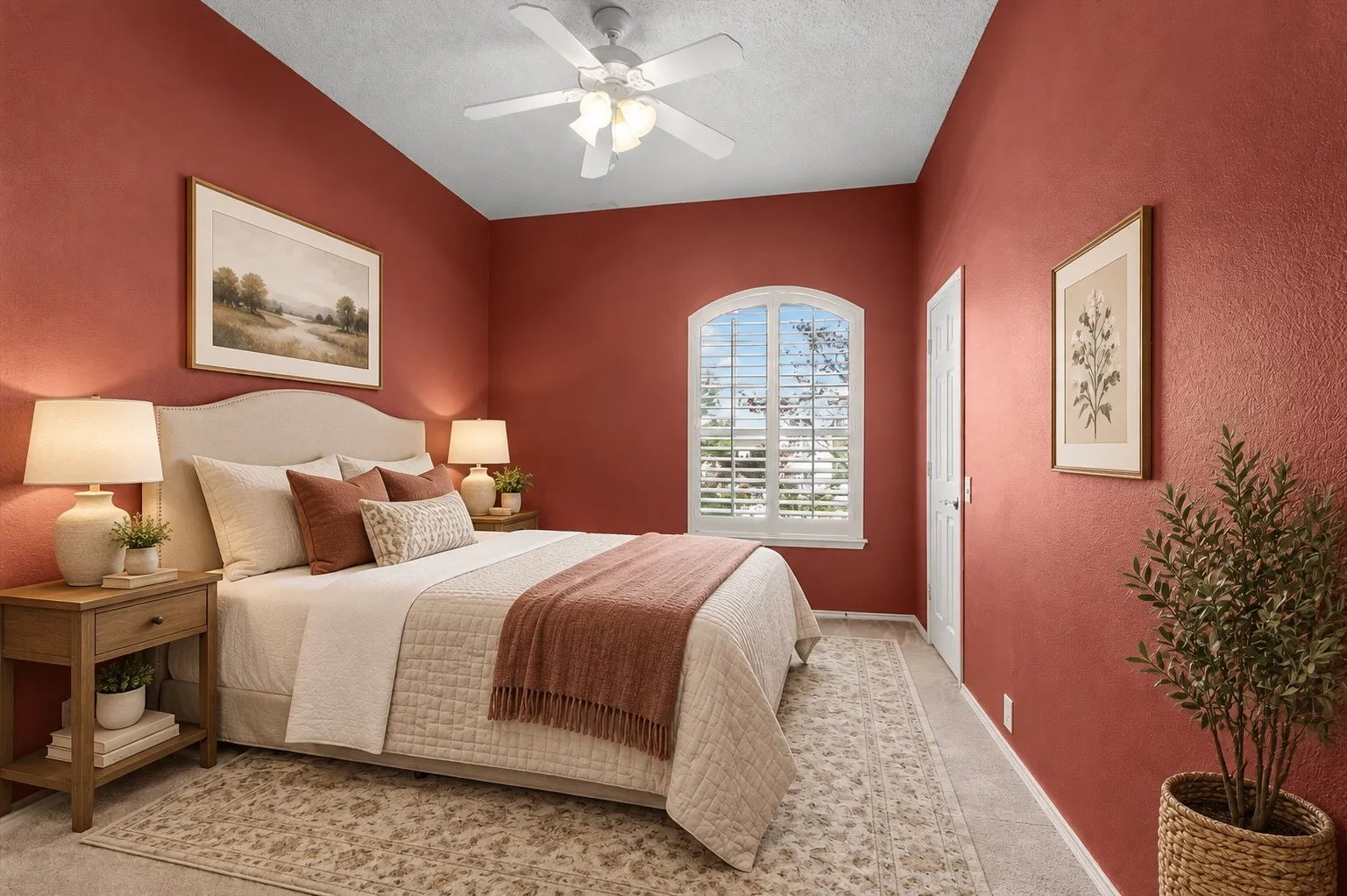 Arched window with plantation shutters, ceiling fan, textured walls, and tile flooring AI staged
