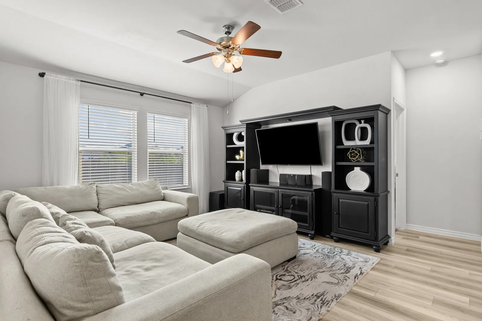 Vaulted ceiling featuring a ceiling fan