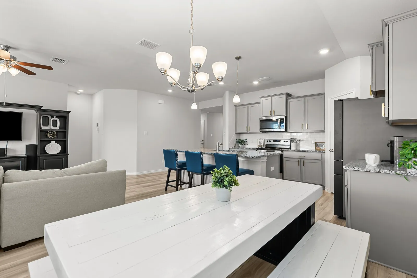 Kitchen featuring gray cabinetry, stainless steel appliances, and a subway tile backsplash