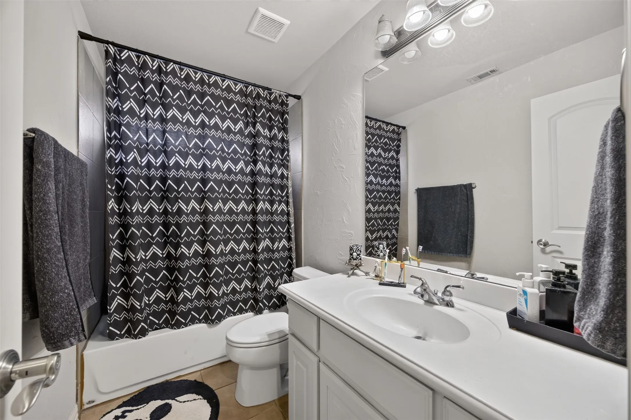 White vanity with a single basin sink and chrome faucet